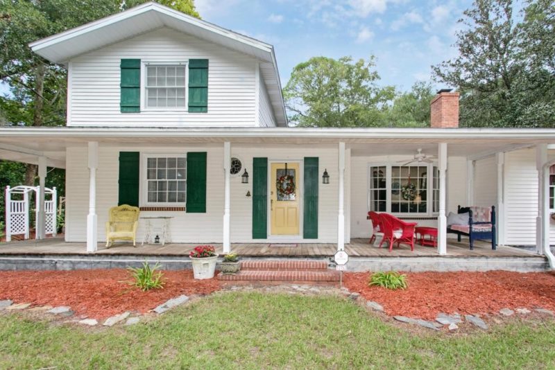 And the BEFORE of how the house looked when we bought it. Lots of primary colors everywhere. Some of the updates I did to the front was paint all the green shutters black, add a screen door, add some rocking chairs, and lots of landscaping!