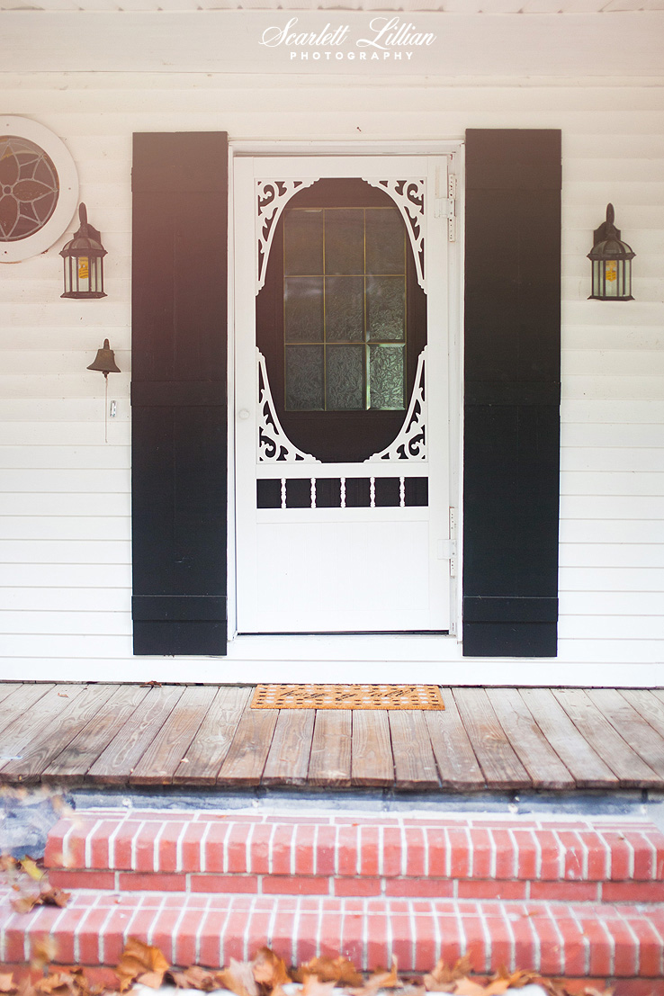 This screen door from Lowes was something I added on. And I painted all the shutters black. They were previously green as you'll see in the before photo at the end of this post. I also love the old school door bell!